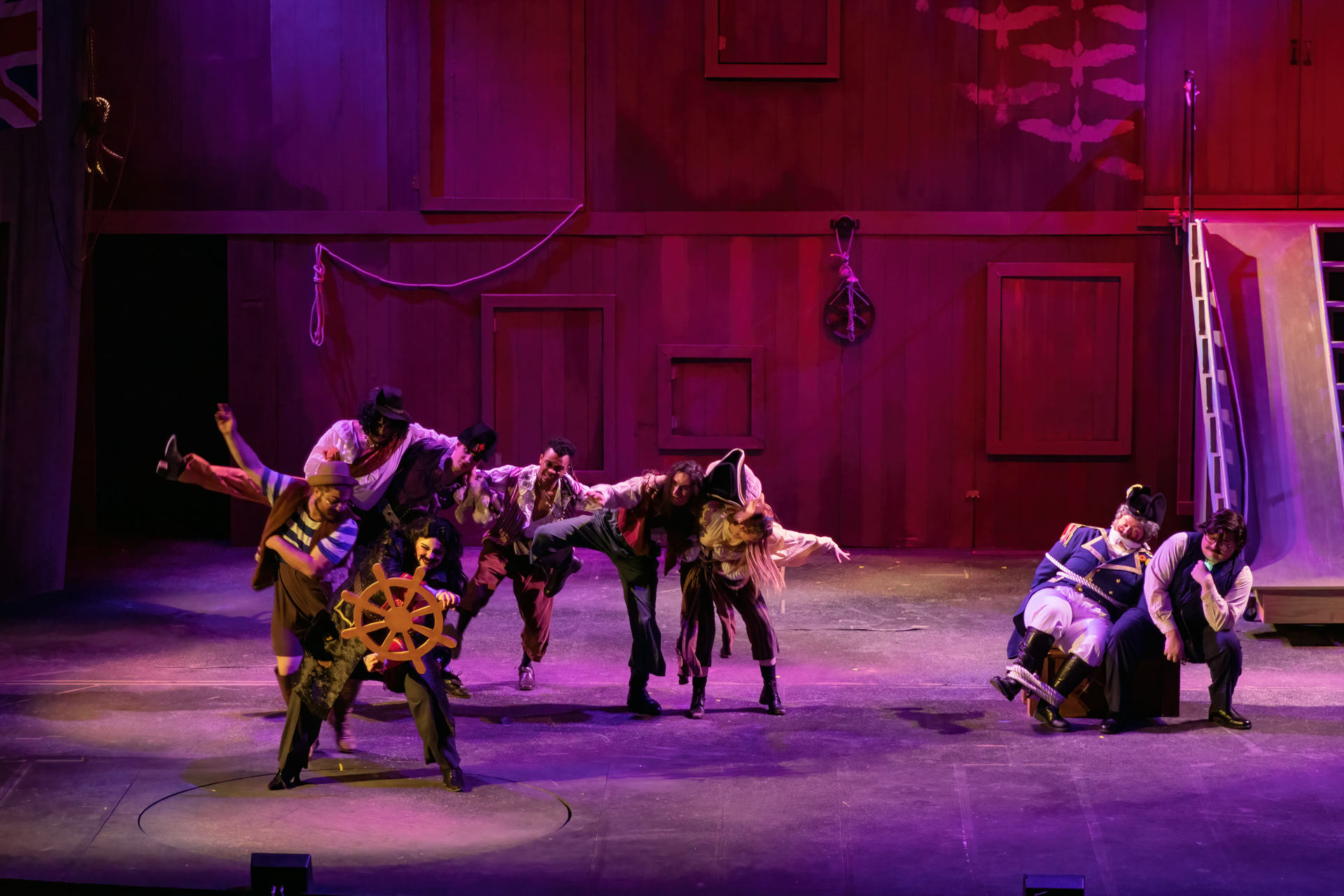 The pirate crew behind Blackstache and Smee as they steer the ship.