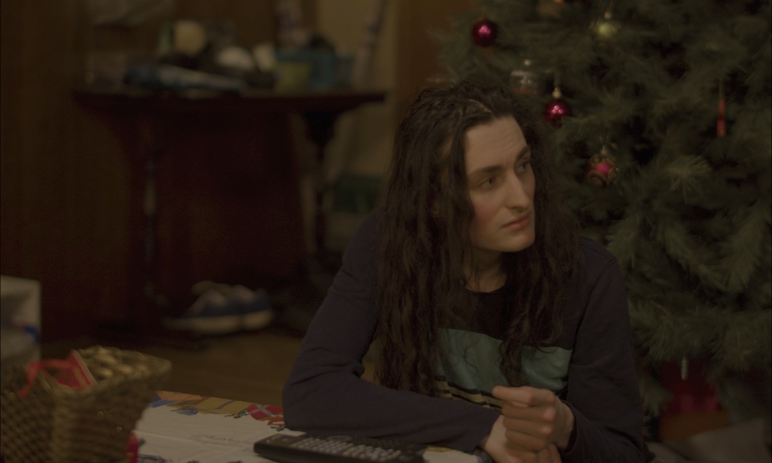 The family sits and watches a performance of another character on a pseudo-stage that in the story they built.