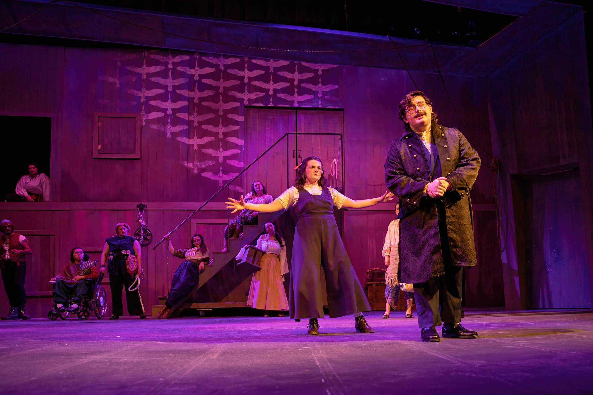 Aster (Austin Hancock) is downstage of a revolving door acting opposite Stevie Longacre playing Molly.