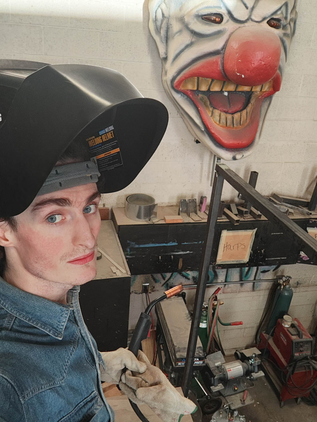 A selfie of me on top of the slide unit, helmet on, taking a break from welding the hand railing together.